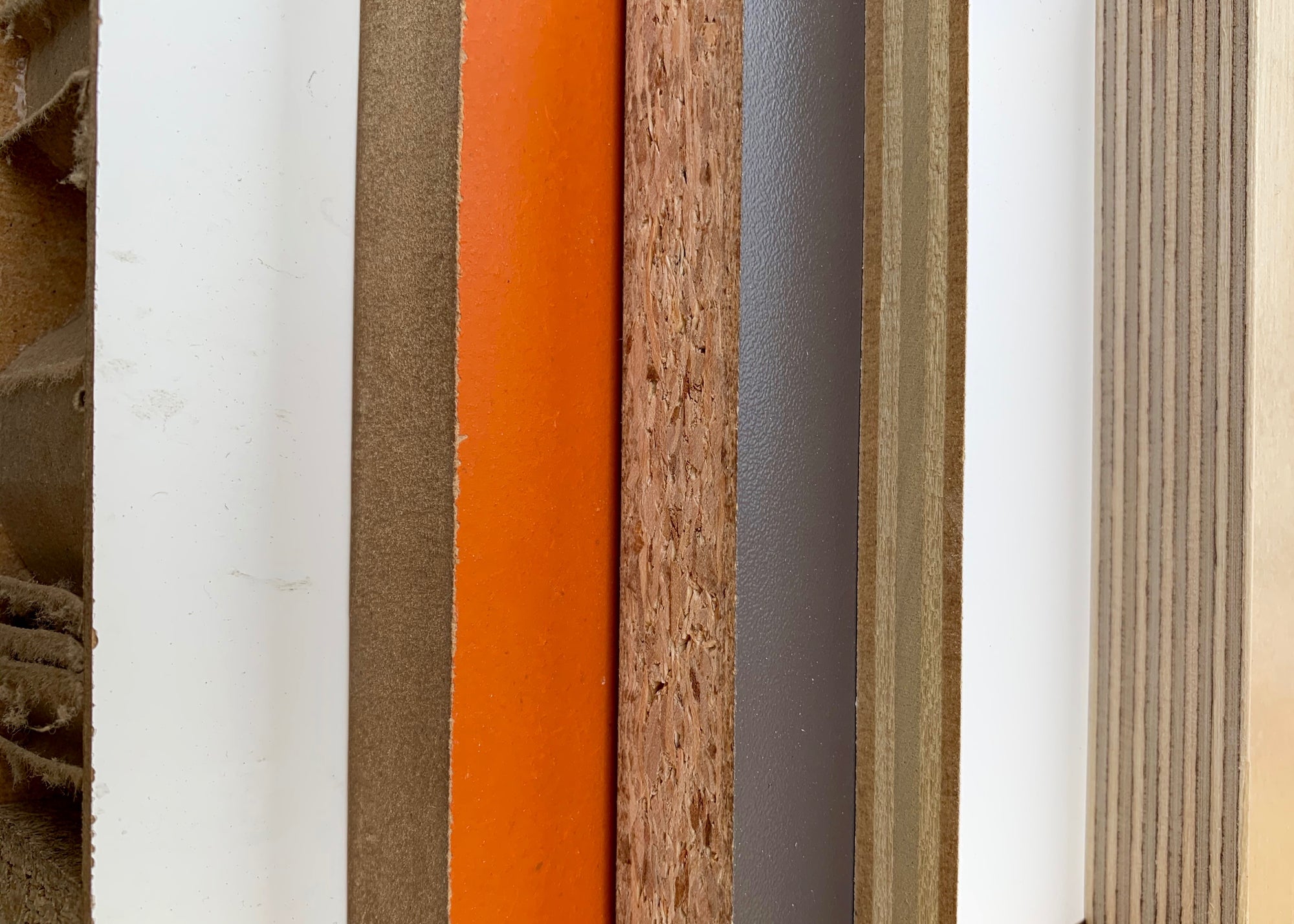 Textured panels in various colors and materials aligned vertically, no text visible.