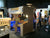 Indoor exhibition booth with people and displays.
