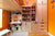 Organized study area with desk, shelves, and cabinets in a room with orange walls.