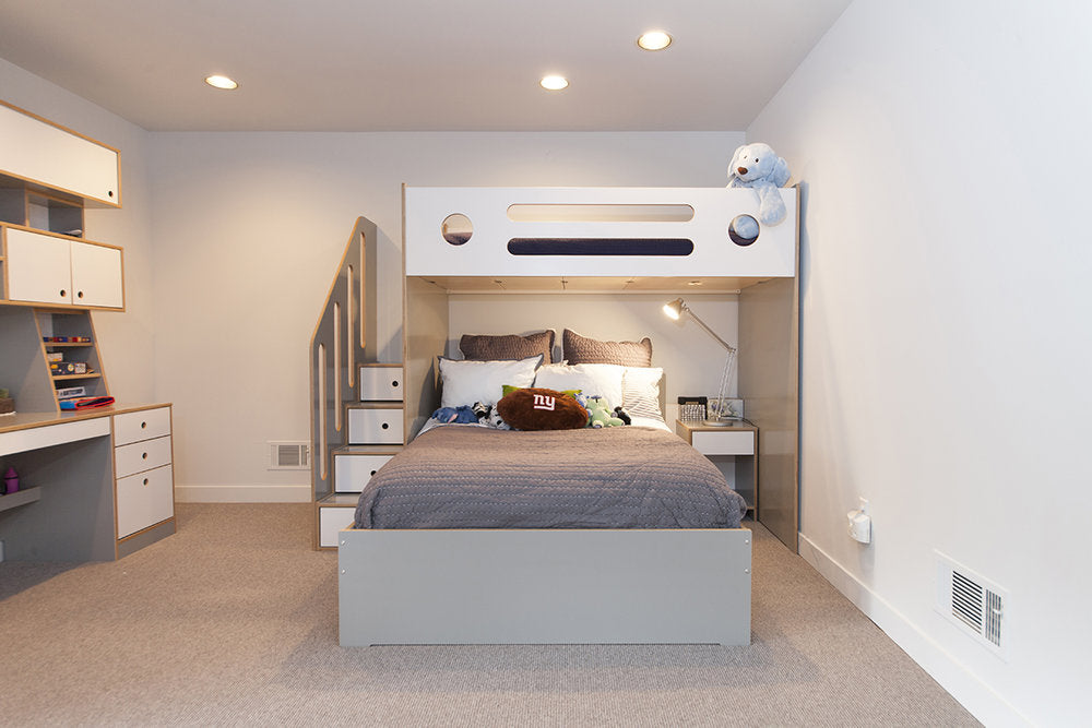 Modern bedroom with a large bed, built-in shelves, and soft lighting.