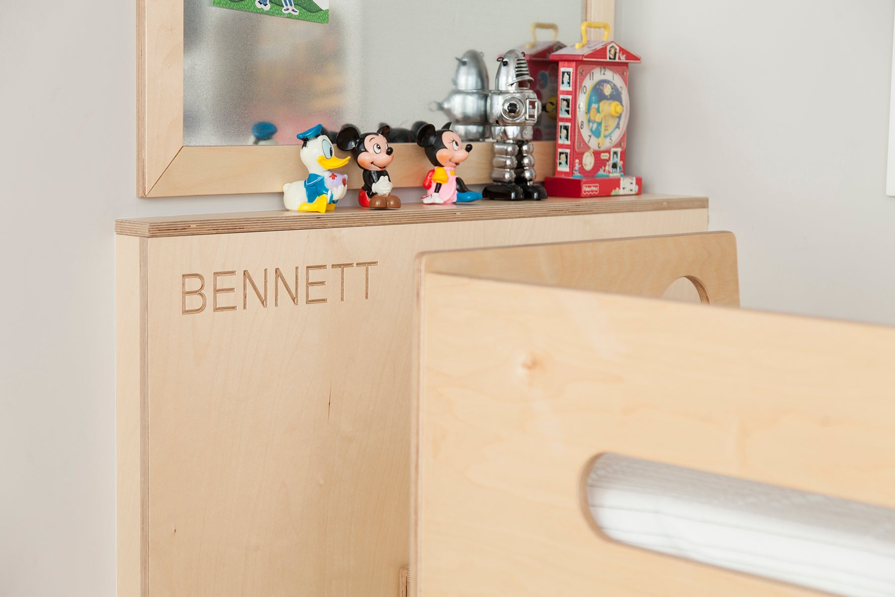 Wooden toy box with ‘BENNETT’ and toys on top.