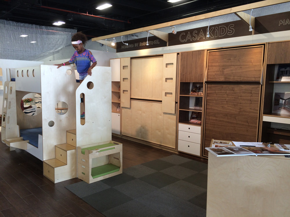 Person climbing on integrated kitchen cabinets with various designs and colors. Modern kitchen setting.