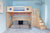 Child’s bed designed like a spaceship with stairs and storage in a blue room.