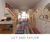 Lily and taylor modern kids' room with a colorful striped rug, loft beds, desks, and wooden storage units.