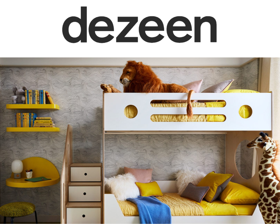 Dezeen themed children's room with a bunk bed, stuffed lion, giraffe, and colorful pillows.