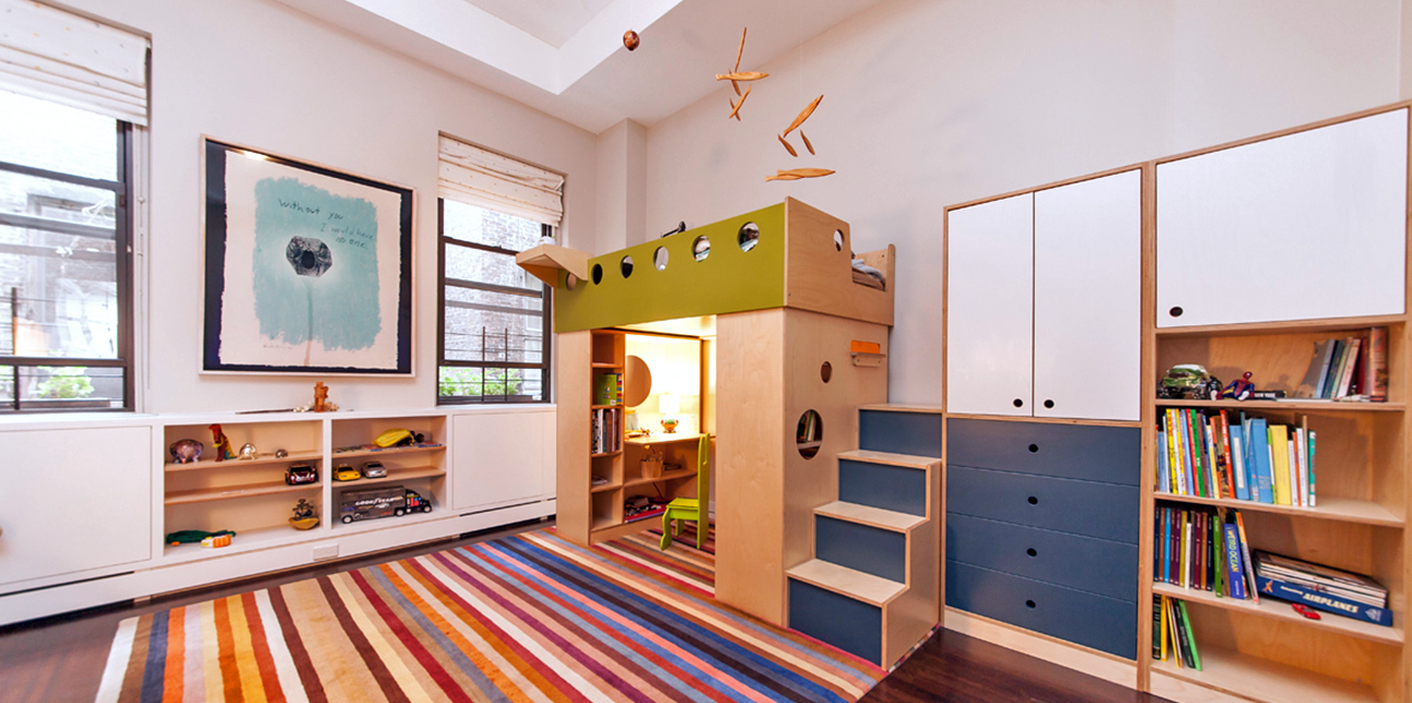 Colorful children's room with a castle-themed loft bed, striped rug, and ample storage solutions.