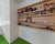 Child’s room with shelves, toys, books, and green carpet.