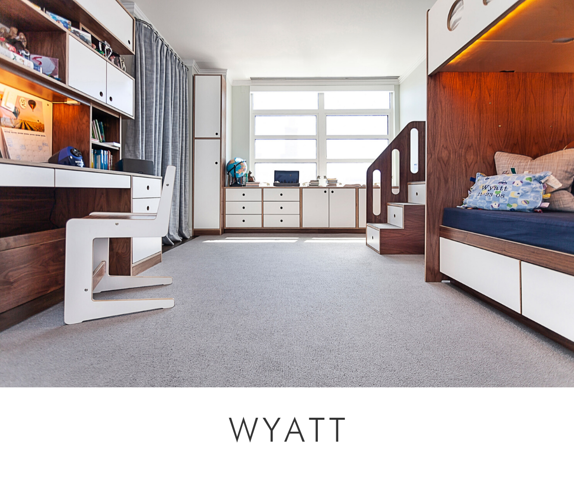 Wyatt room children's room with dark wood beds, built-in desk, ample storage, and a large window.