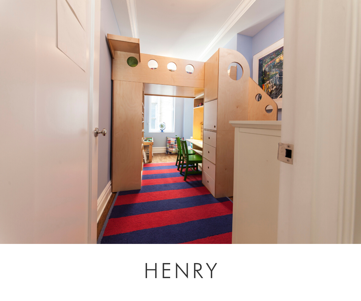 Henry room narrow hallway with striped rug leading to a child's room with loft bed and wooden storage.