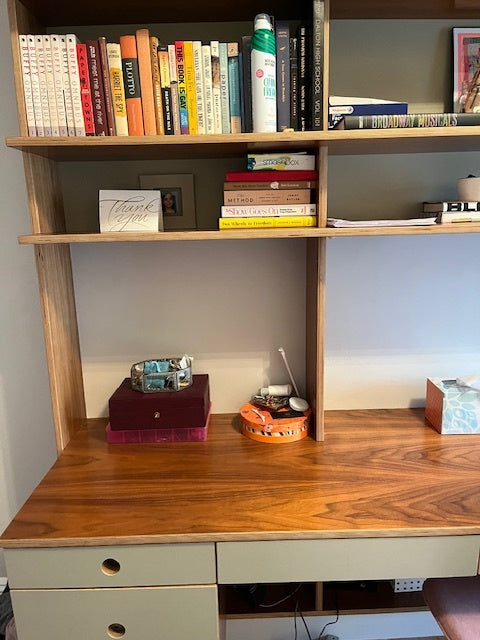wooden desk and shelf unit with books, close-up view