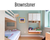 Modern child's bedroom with green walls, a bunk bed, white cabinets, and a play area.