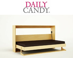 Modern bench with black seat, wooden frame, ‘DAILY CANDY’ logo above.