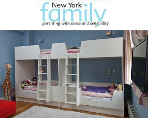 Spacious children's room with twin bunk beds, integrated ladders, and a cozy blue wall backdrop.