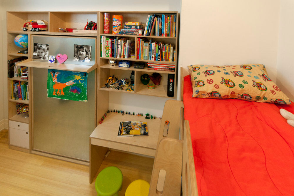 Cozy bedroom with bookshelf, desk, and single bed.