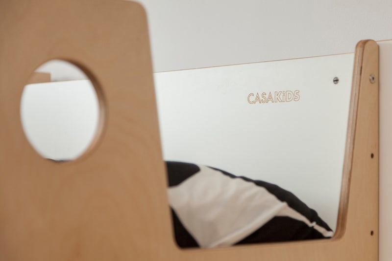 Wooden chair with circular cutout in front of “CLASSIC” sign.
