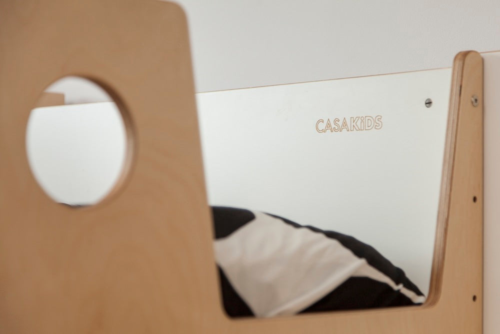 Wooden chair with circular cutout in front of “CLASSIC” sign.