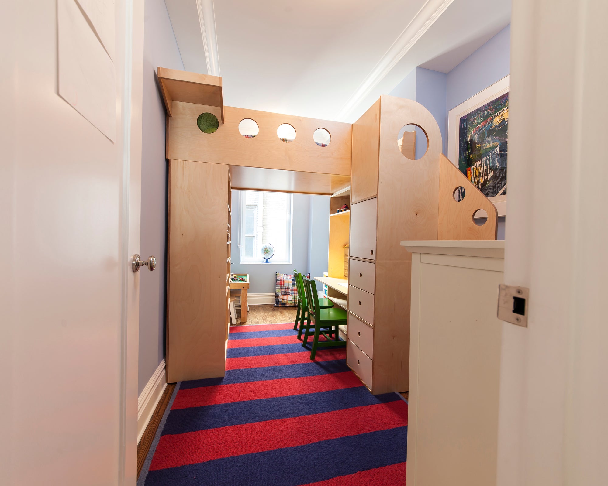 Colorful hallway with striped carpet, wooden furniture, and vibrant decor