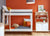 Children’s room with bunk bed, desk, plush toy, and colorful decor.