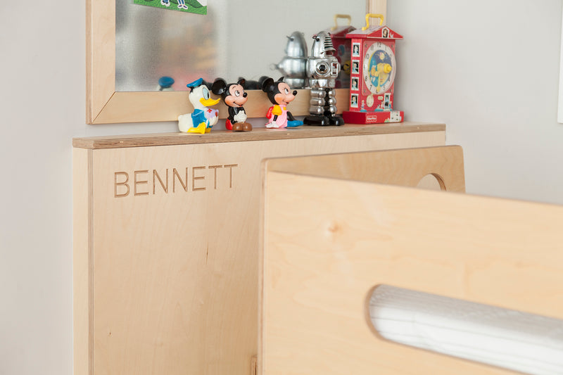 Wooden toy box with ‘BENNETT’ and toys on top.