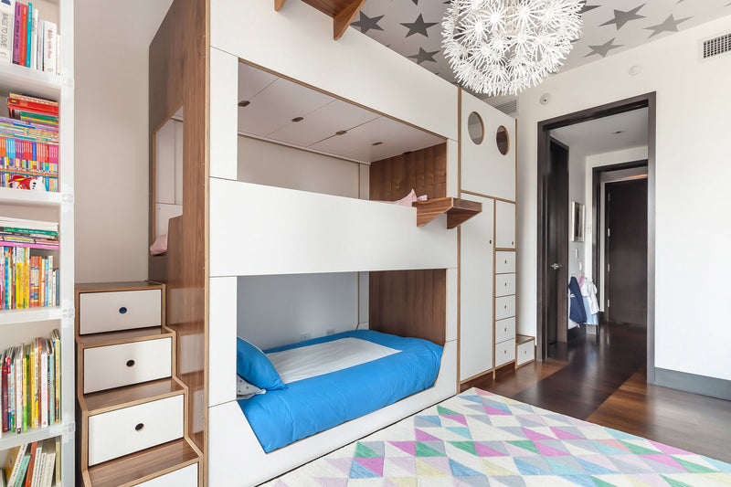 Modern children's bedroom with built-in bunk beds, colorful rug, and star-patterned ceiling.