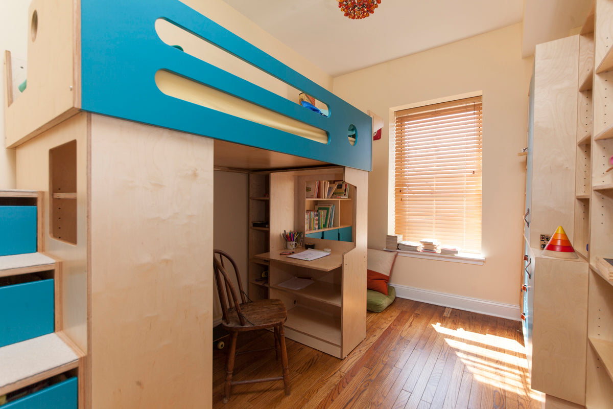Child’s bedroom with blue loft bed, desk, bookshelf, and window.