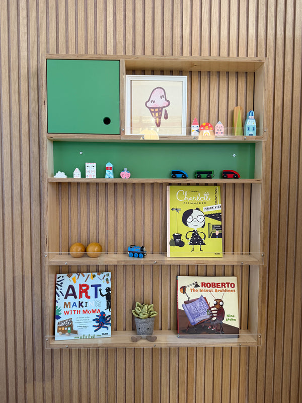 Square shelf built into wood wall with kid's books and toys