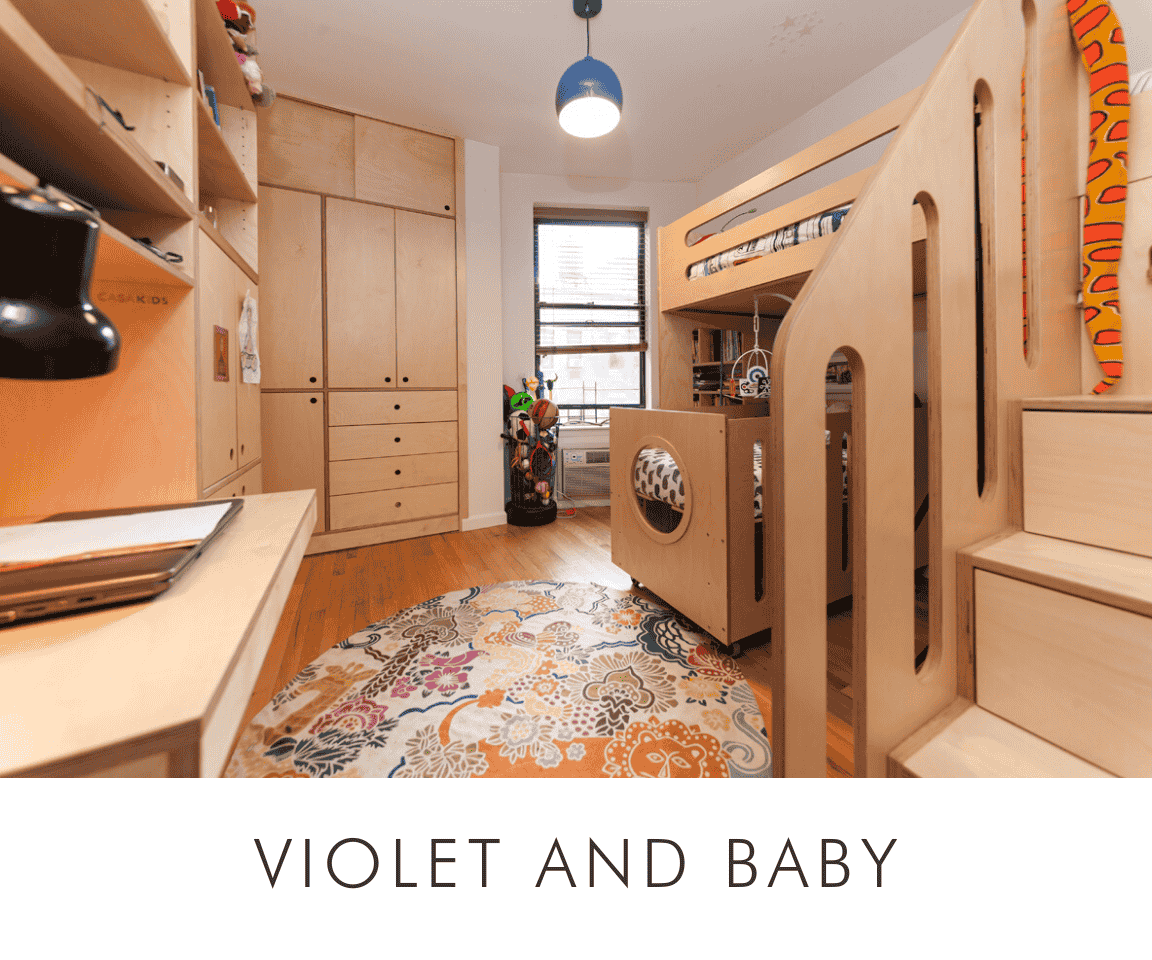 Violet and baby cozy room with floral rug, custom wooden bunk bed, cabinetry, and a study desk with a lamp.