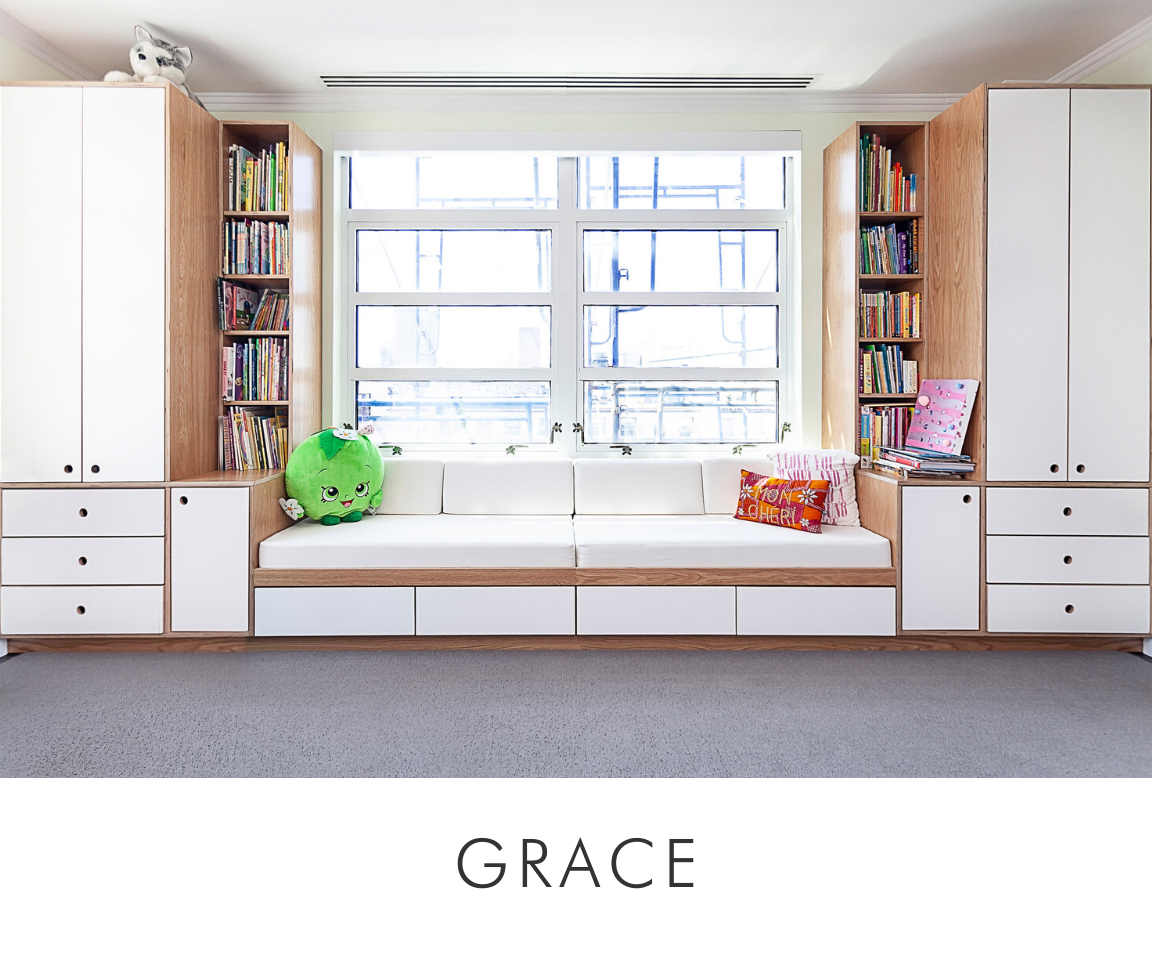 Grace room cozy reading nook with built-in white cabinets, bench, cushions, and a window with greenery.