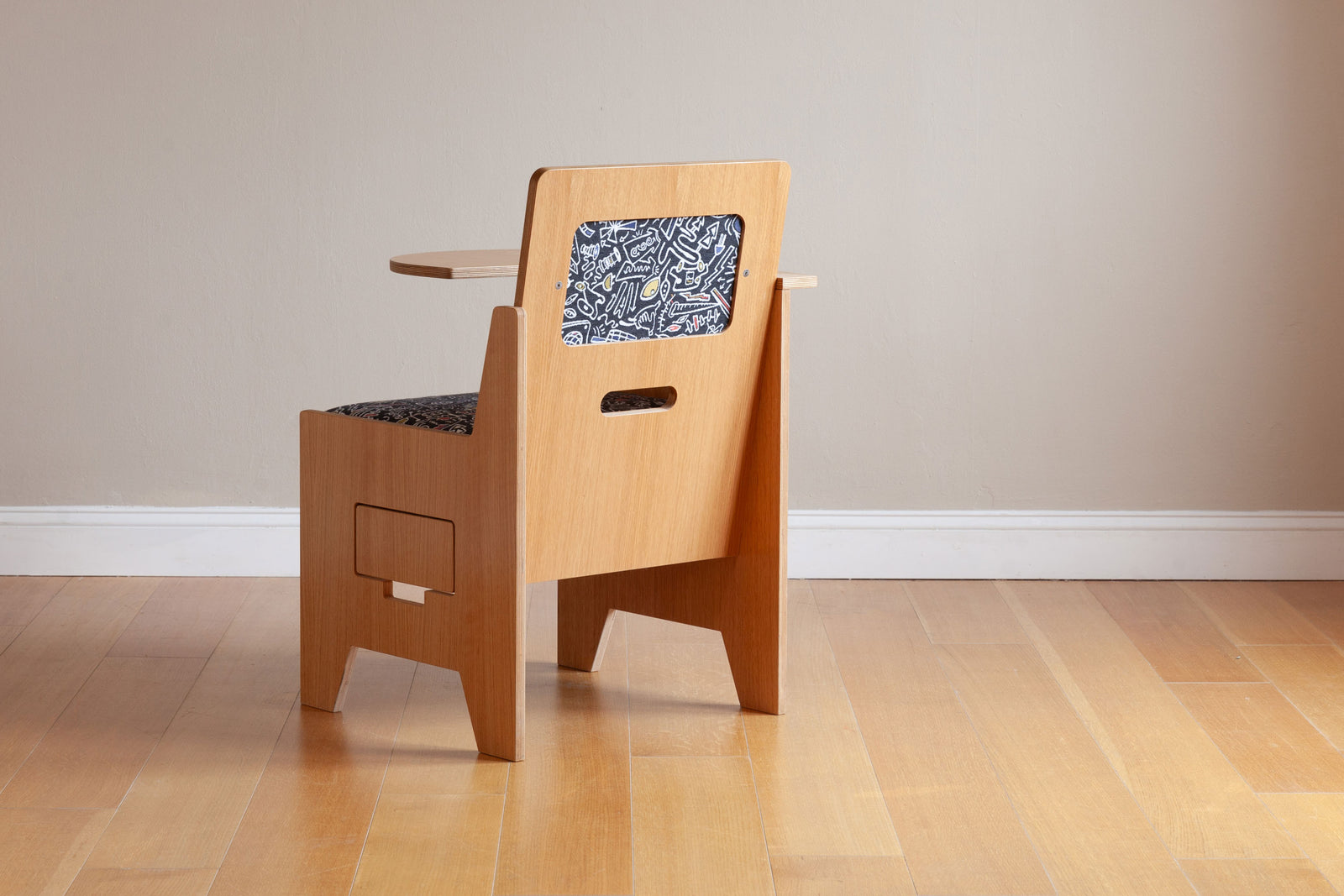 Back view of oak work desk for adults with custom graffiti upholstery. 