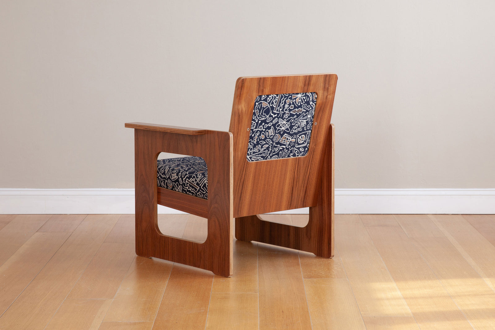 back view of walnut armchair with custom graffiti upholstery