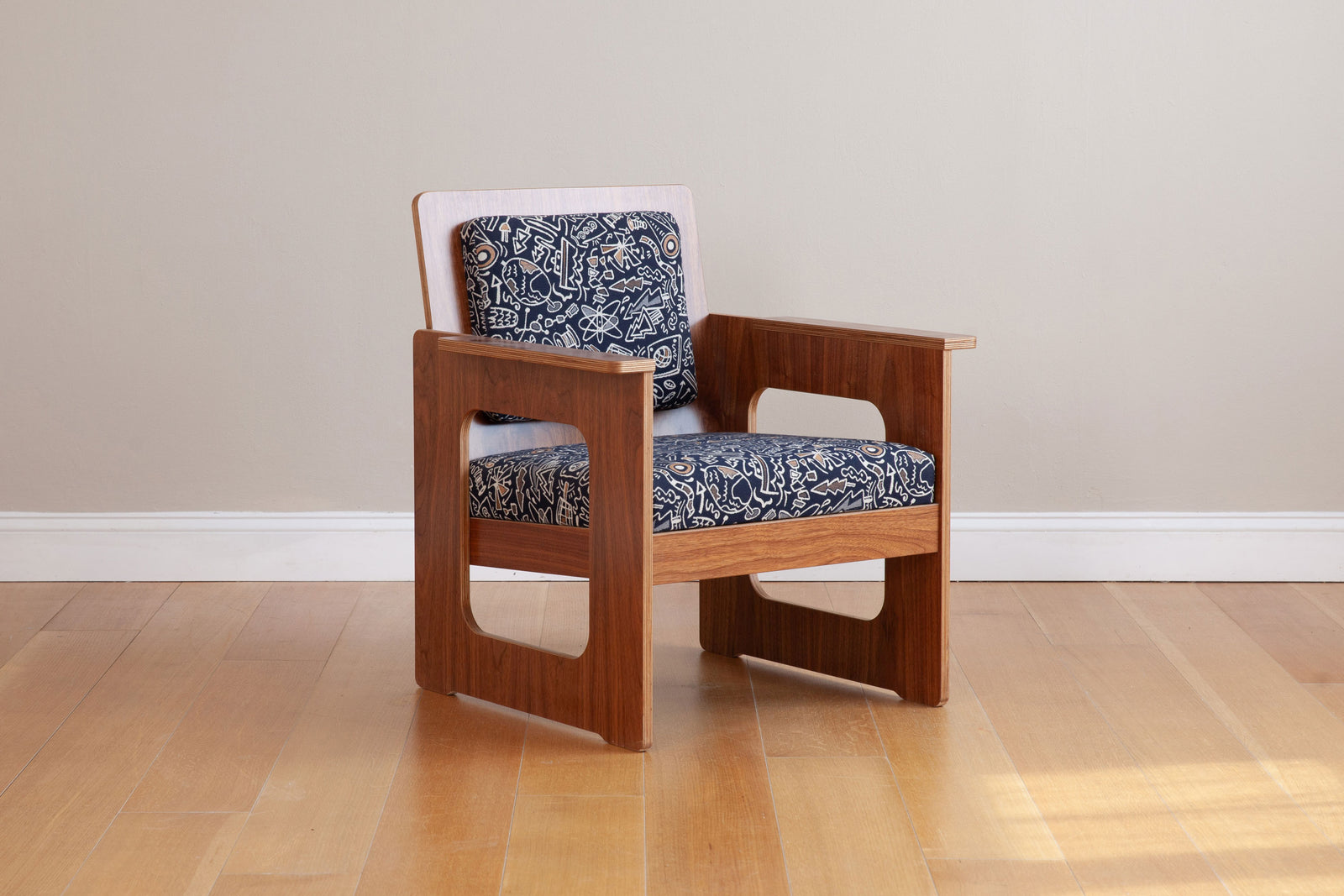 front side view of walnut armchair with custom graffiti upholstery