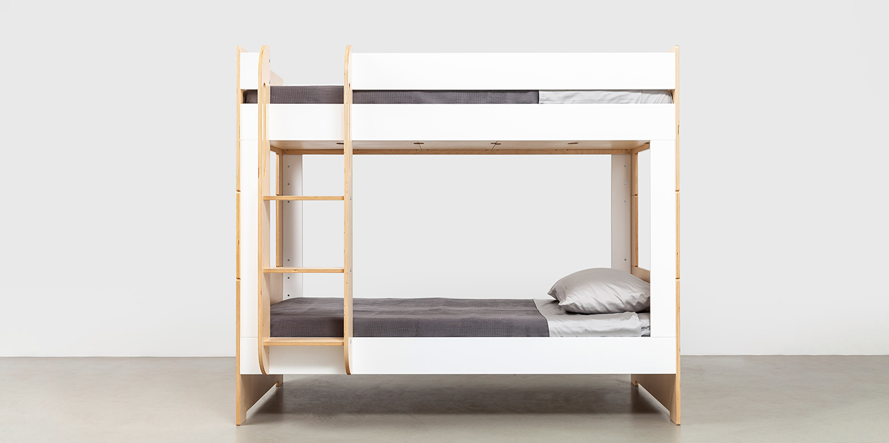 Modern wooden bunk bed with a natural finish, white panels, and gray bedding, featuring an integrated ladder.