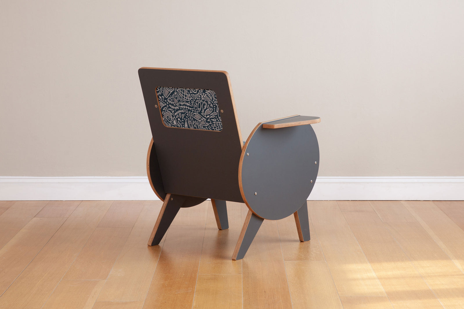 back view of gray armchair with custom graffiti upholstery