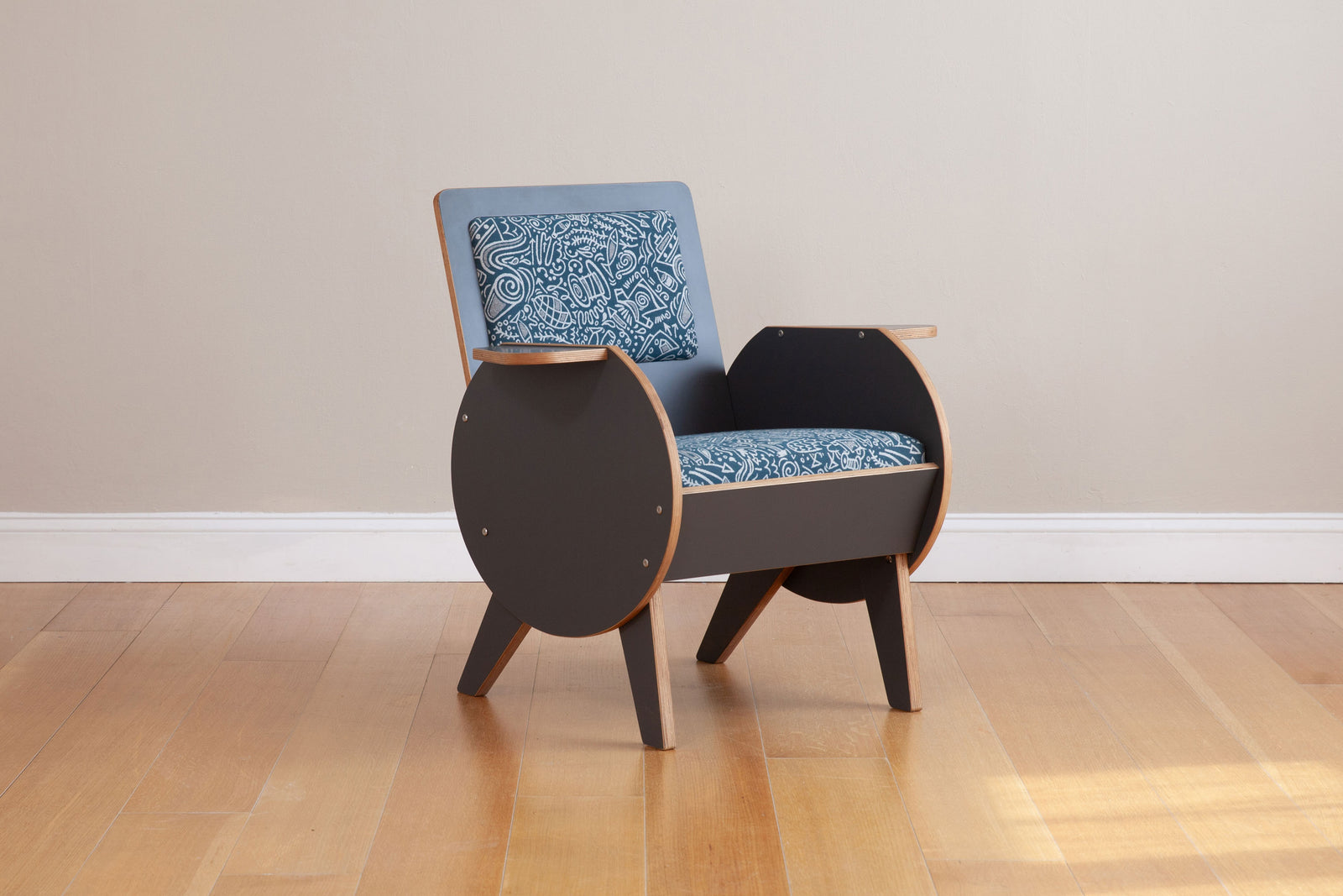 front side view of gray armchair with custom graffiti upholstery