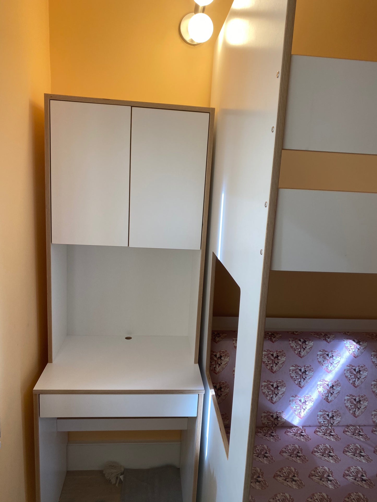 White loft bed over daybed and desk