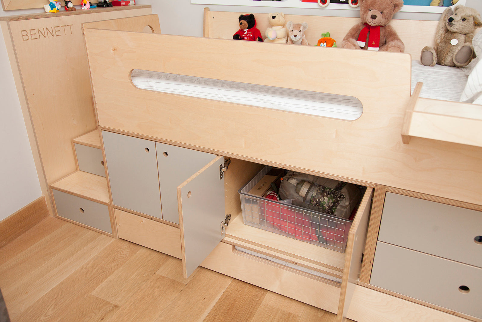Wooden bunk bed with drawers, teddy bears included.