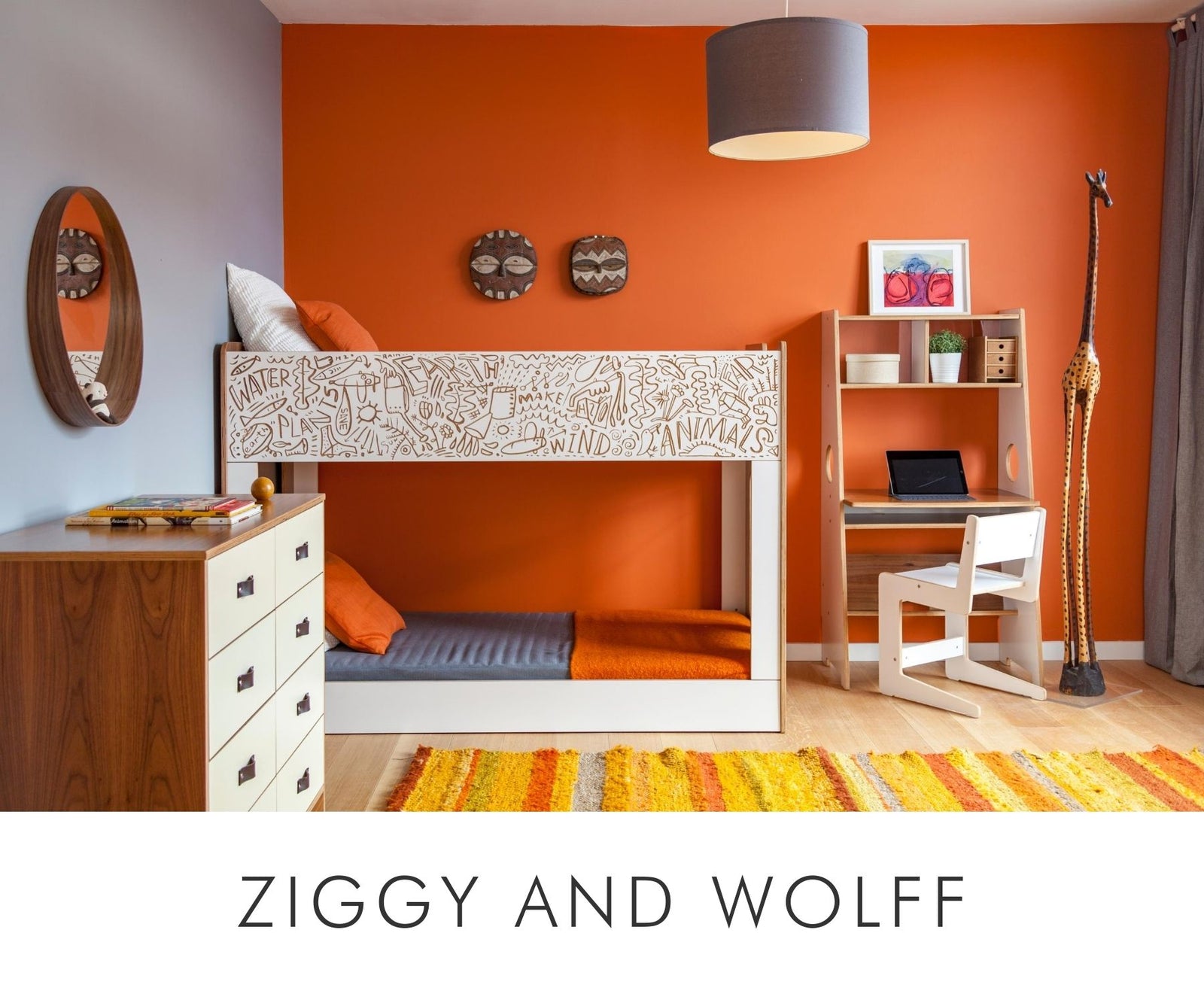 Vibrant room with an orange wall, patterned bunk bed, striped rug, and a desk with chair.