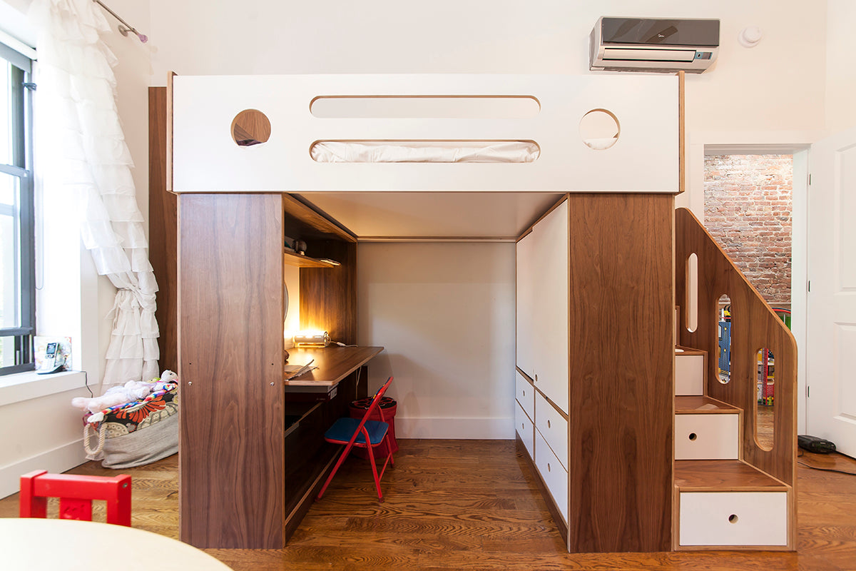 Children's room with a loft bed featuring a wooden frame, study area below, stairs with drawers, and a wall-mounted air conditioner.
