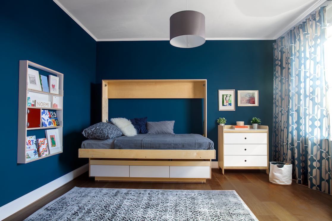 Unique room design with a floating bed, patterned ceiling, dark walls, and stylish window curtains.