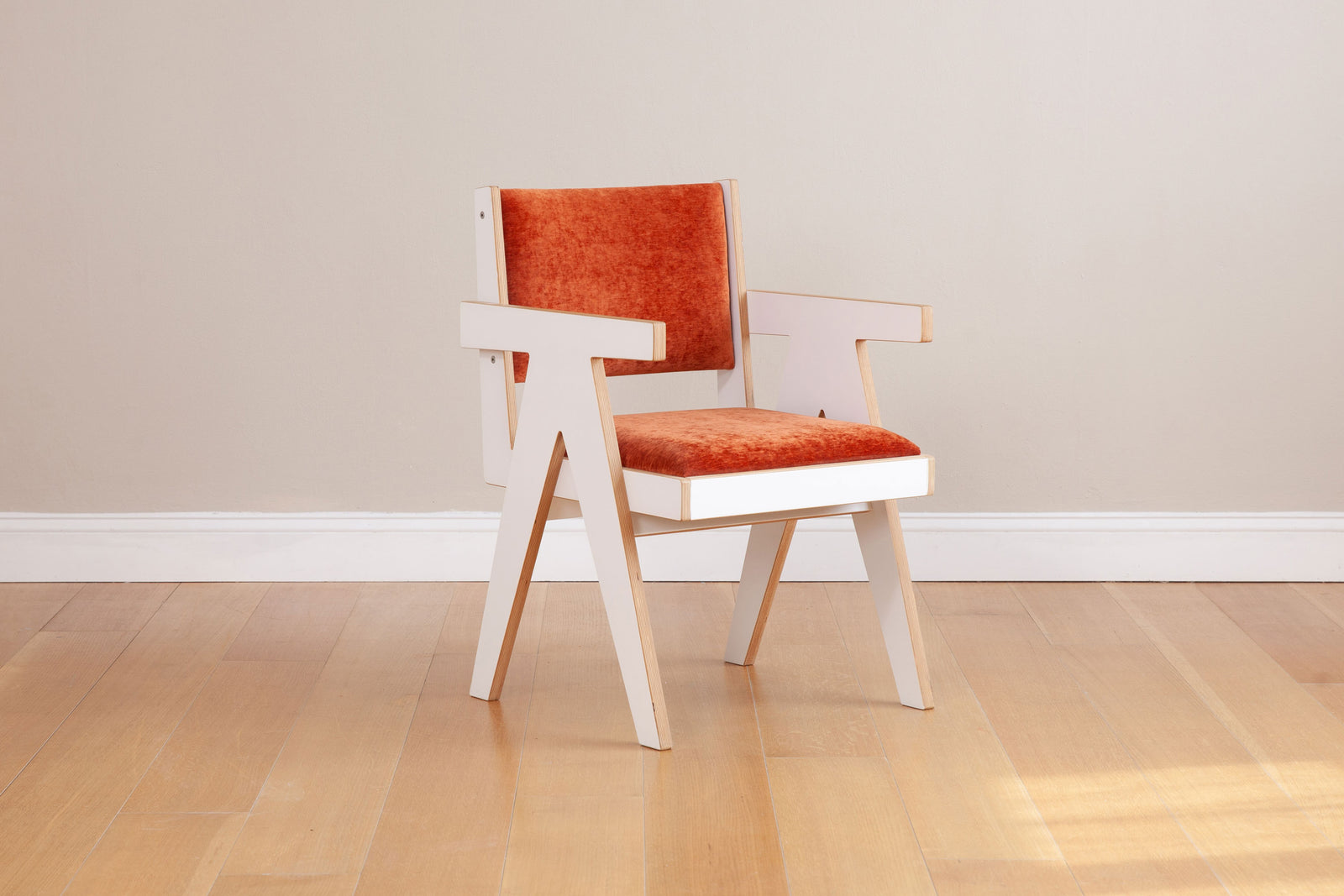 white armchair with custom orange upholstery front view
