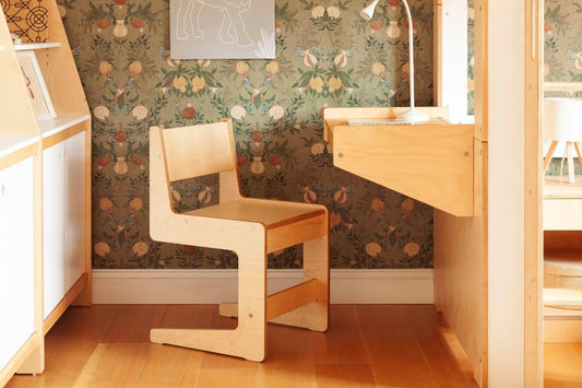 Cabina Chair with desk-side view-Casa Kids. Green natural wall papered room with light wood armless chair next to matching floating desk attached to cabina bed.