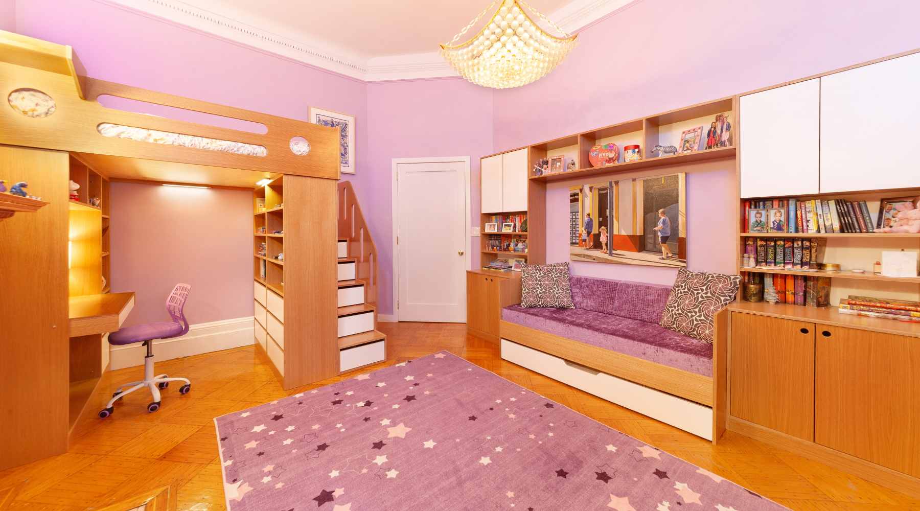 Full-size Dumbo loft bed with a built-in desk and storage cabinets, complemented by a cozy bench with a trundle bed and flanking modular storage units, in a vibrant purple room with a white oak finish.