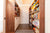 hallway of bookcase and storage units in walnut finish with white accents