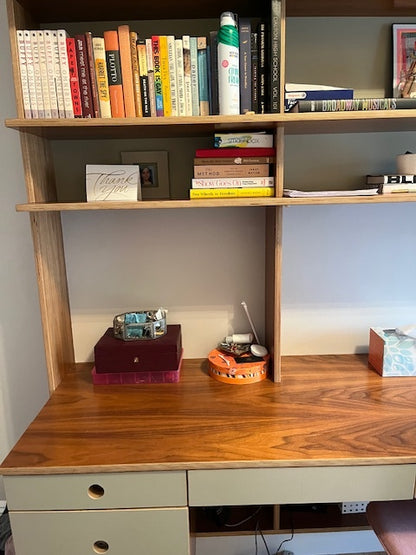 wooden desk and shelf unit with books, close-up view 