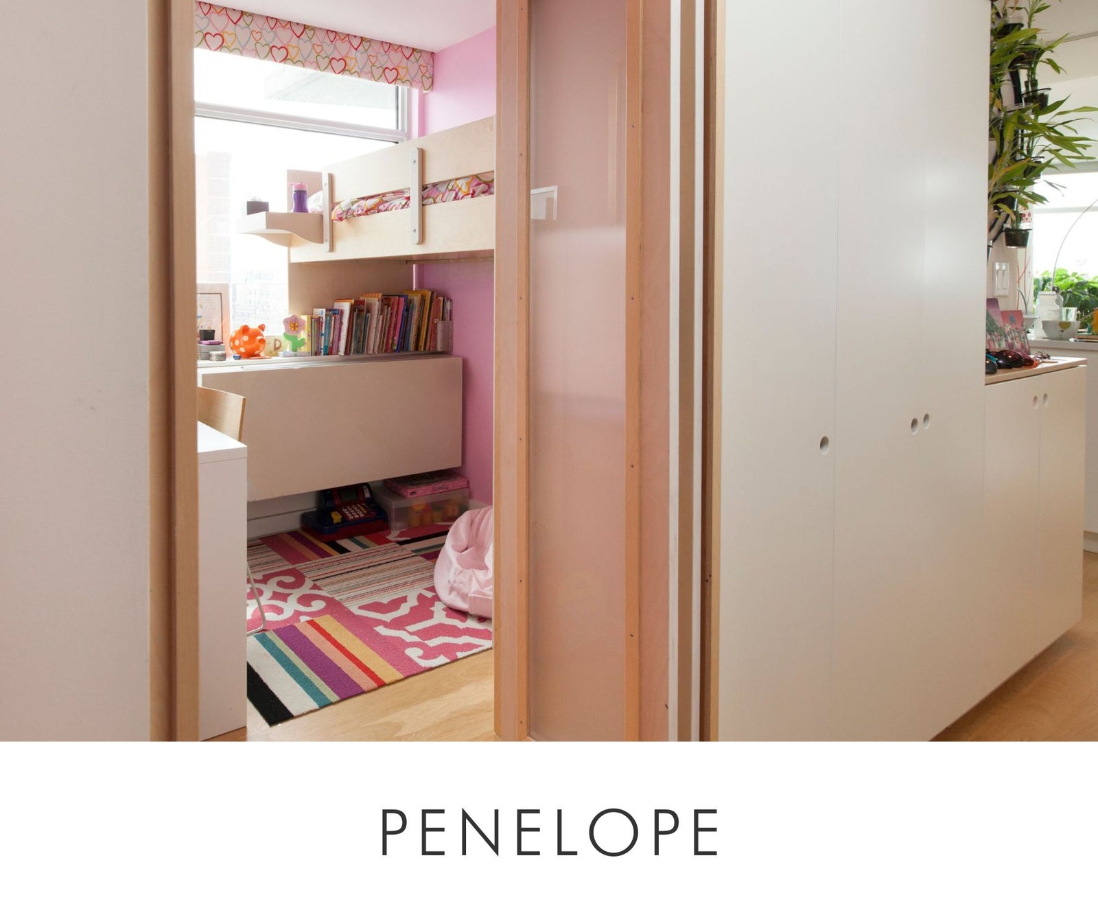 View through custom birch and white cabinetry into child's bedroom featuring a built-in loft bed, desk, and colorful rug.