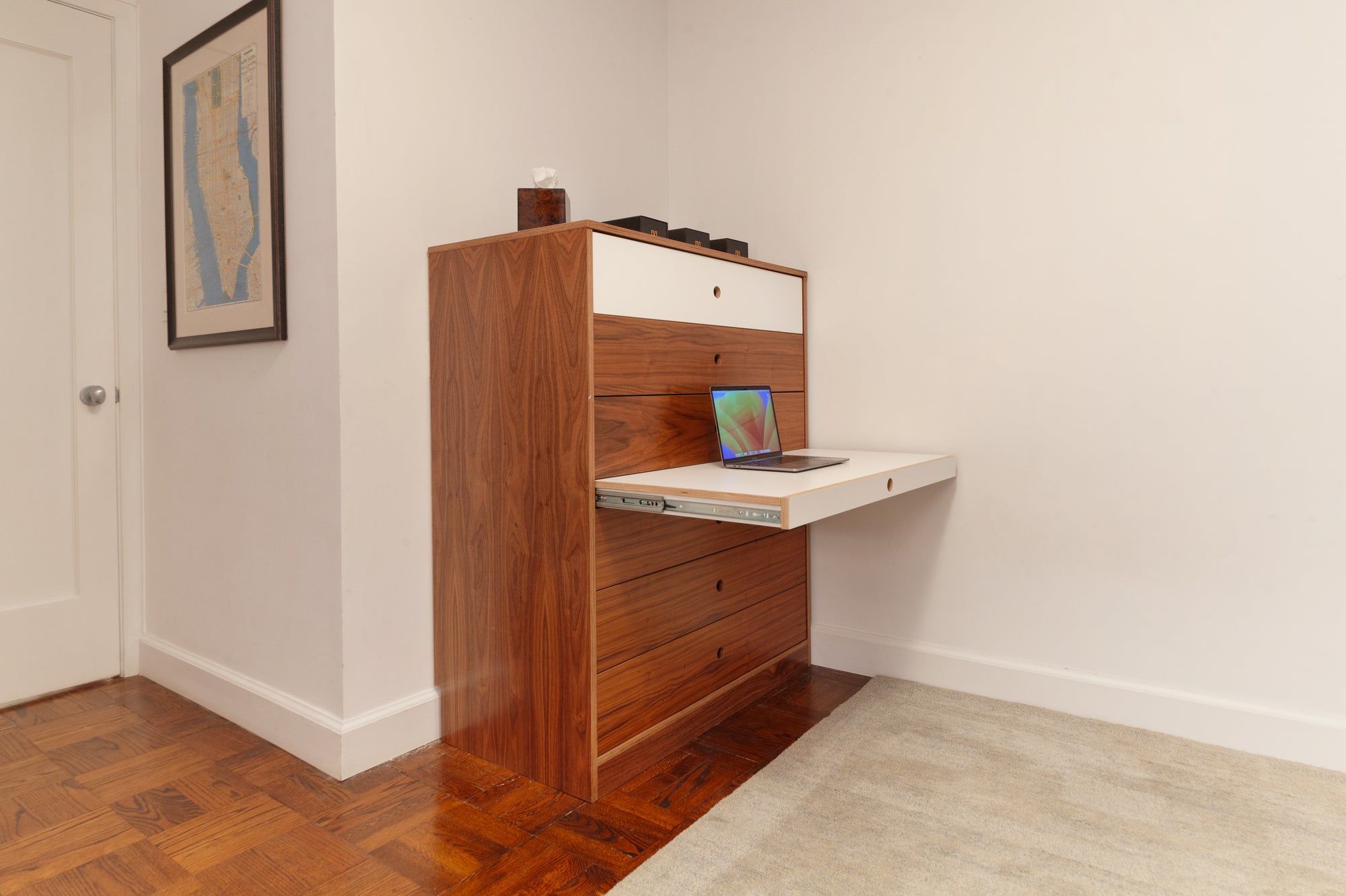 Walnut dresser with a pull-out tray designed for laptop use, featuring a white accent drawer and sleek, minimalist design. Ideal for maximizing functionality in small spaces by providing both storage and a compact workspace.

