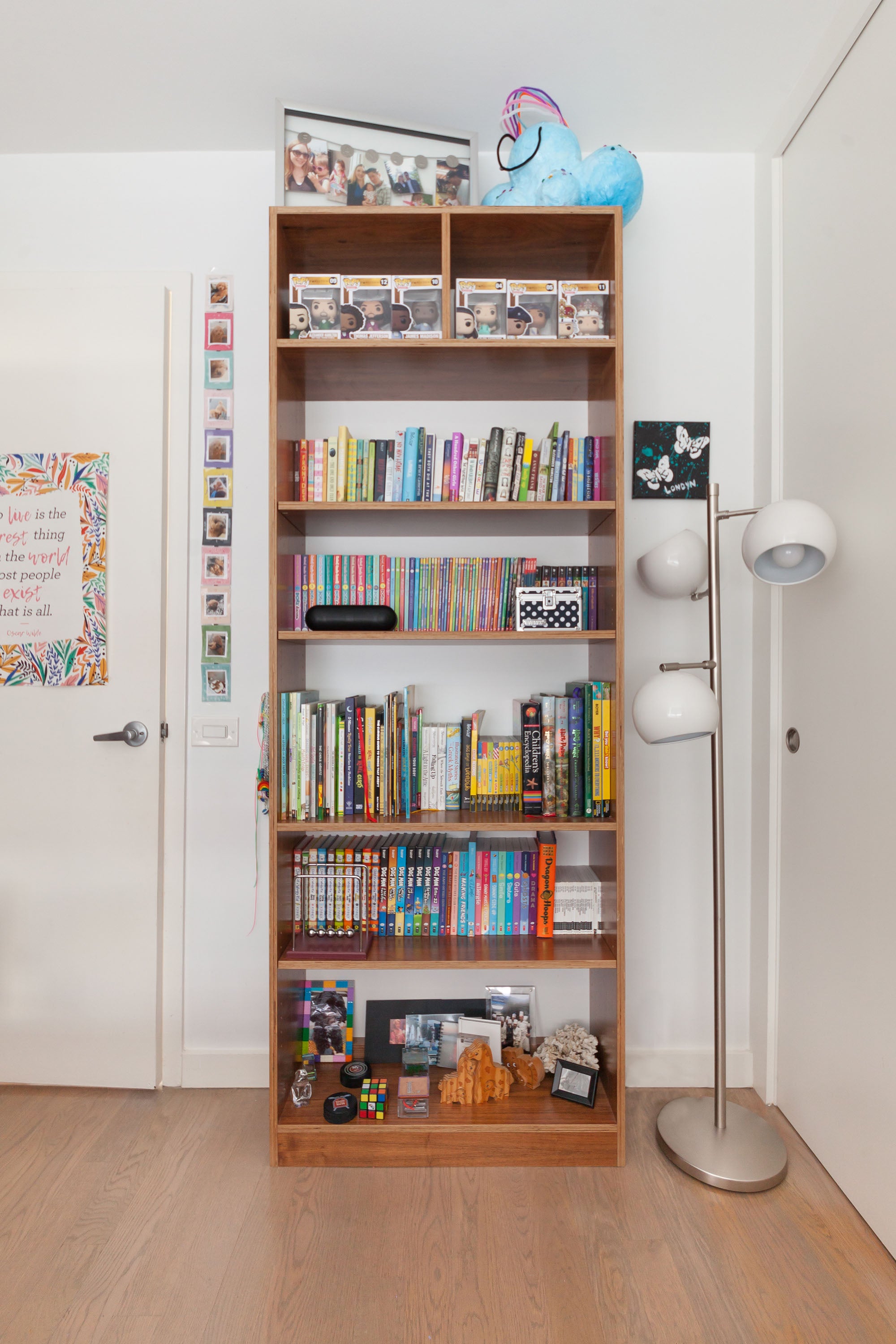 walnut bookcase with books and display items