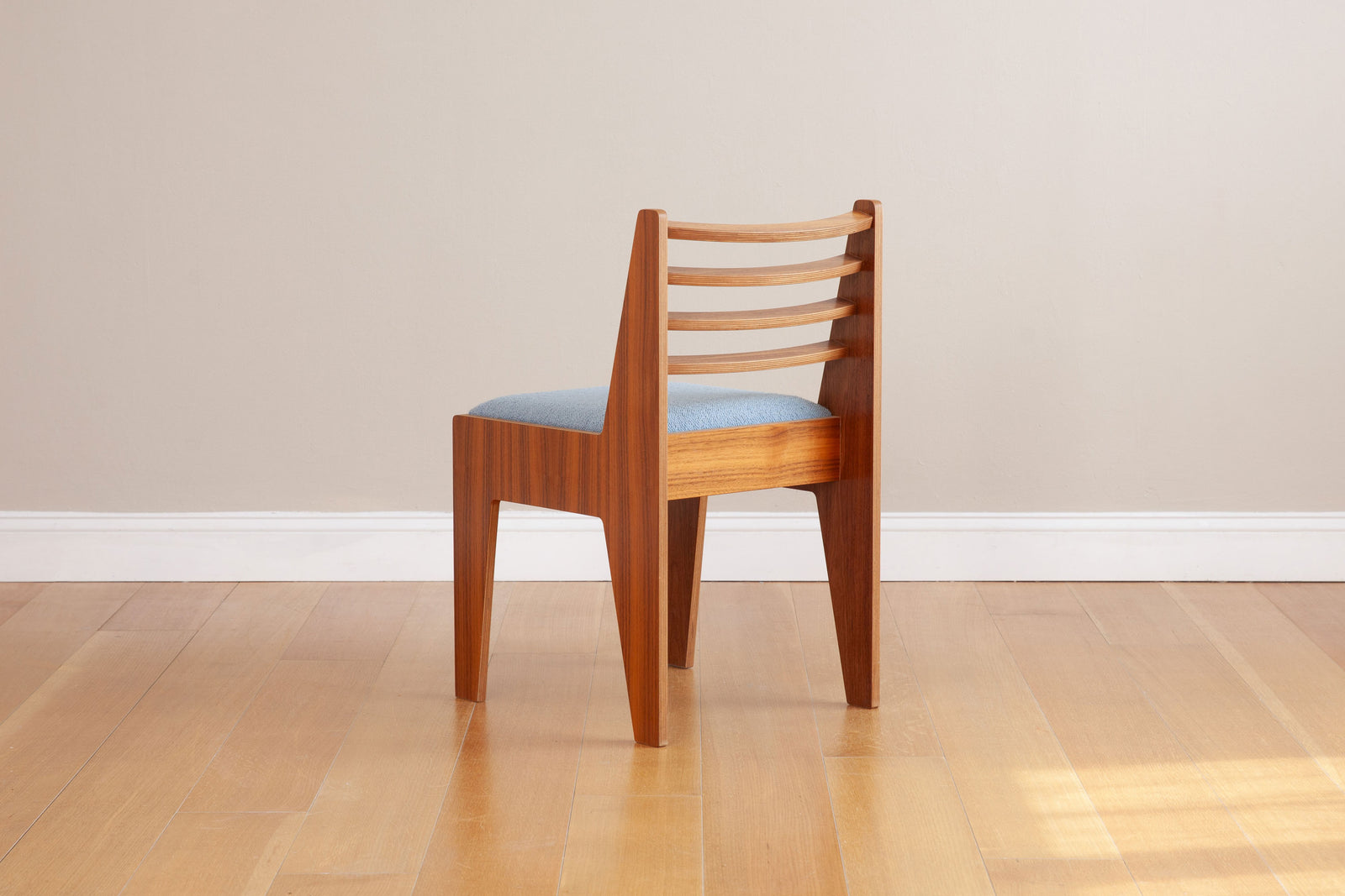 back view of walnut dining chair with light blue upholstery