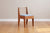 front view of walnut dining chair with light blue upholstery
