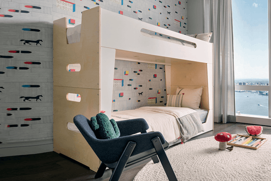 Modern kids' bedroom featuring the LoLo Bunk Bed in white and wood, styled with a blue lounge chair and patterned wallpaper